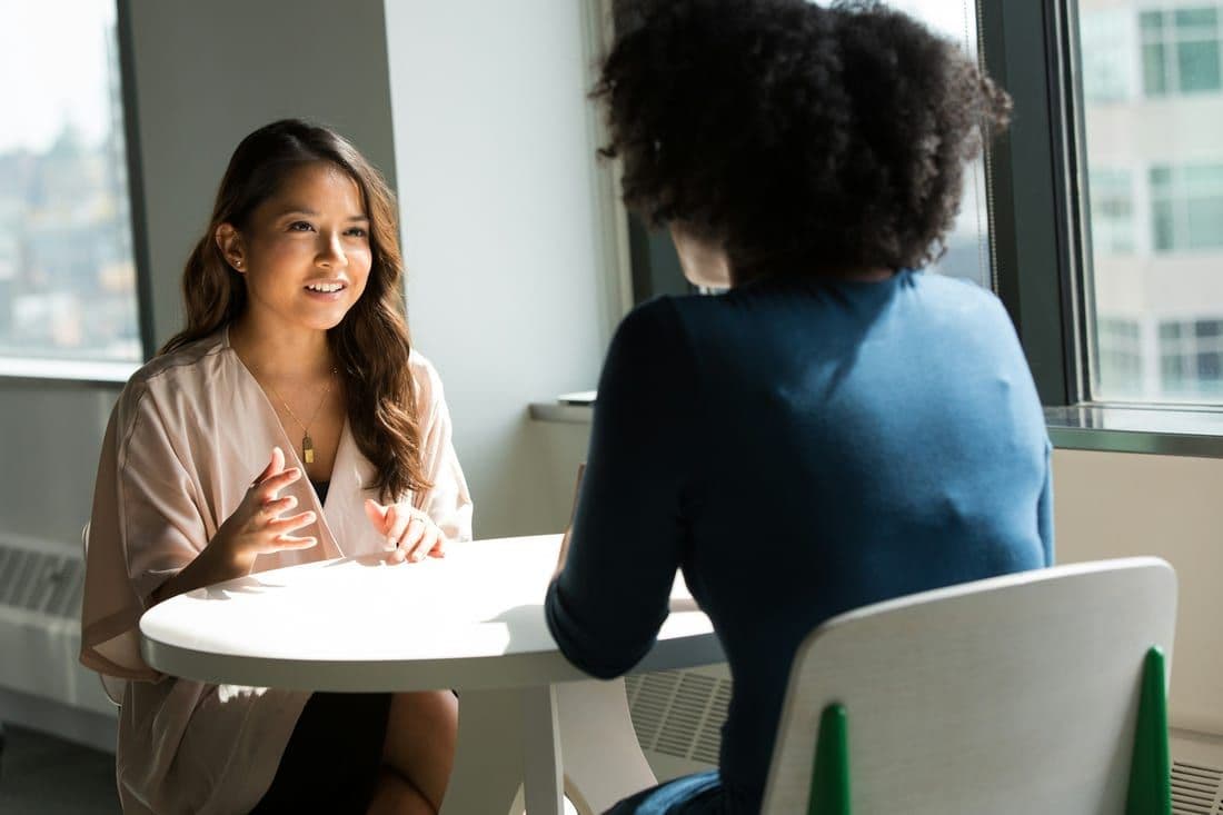 An advisor reviewing a commercial policy with a business owner at a table